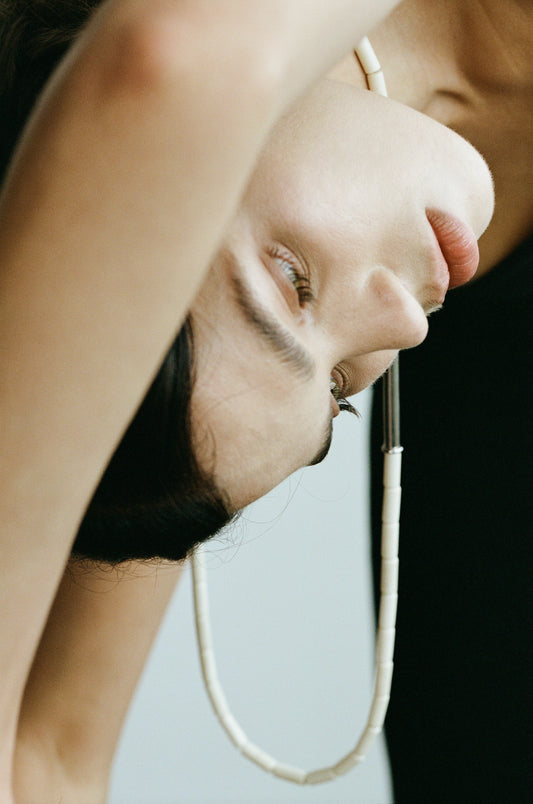 River Rhythm Necklace by RIVERLAKE featuring an antler design with intricate detailing and a natural finish.