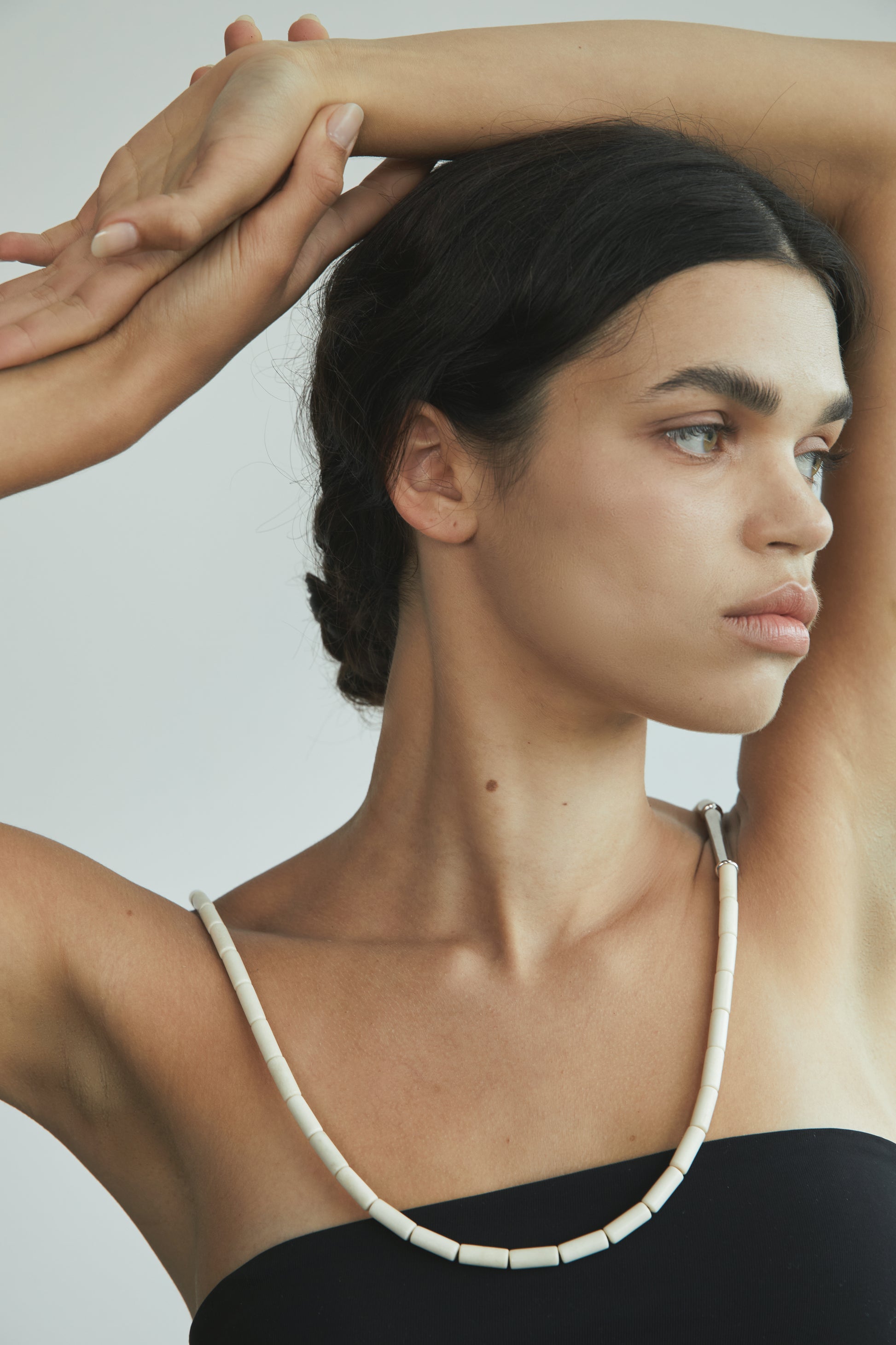 River Rhythm Necklace by RIVERLAKE featuring an antler pendant on a delicate chain against a neutral background.